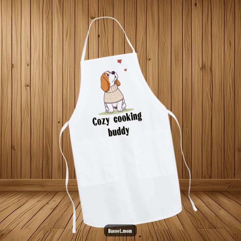 Funny Basset Hound apron featuring a dog in a knitted sweater looking up at a kite, a humorous and stylish kitchen accessory.