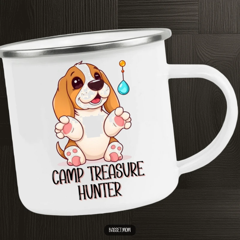 Funny Basset Hound camping mug showing a dog with paws up, playfully batting at a dangling jewel, ready for outdoor fun and discovery.
