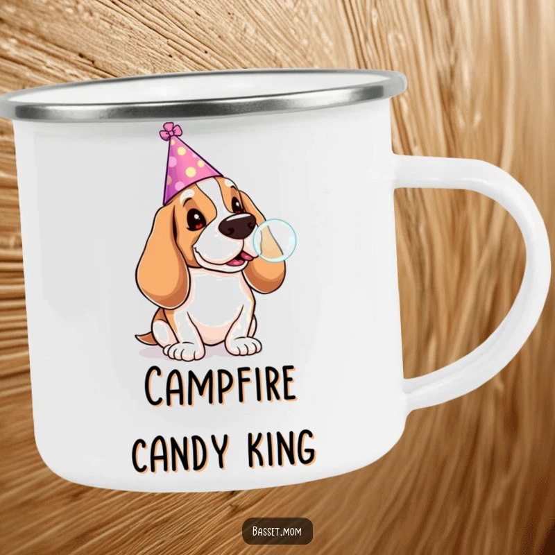 Funny Basset Hound camping mug showing a dog in a party hat blowing a lollipop bubble, adding festive cheer to outdoor drinks.