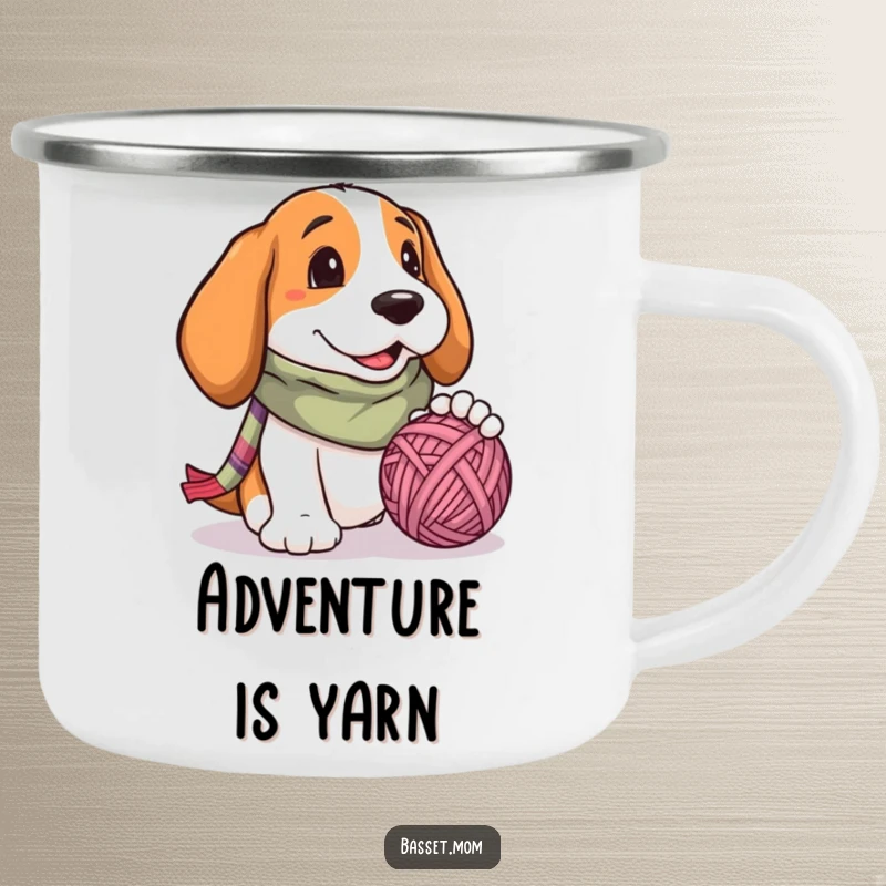 Funny Basset Hound camping mug, a dog with a scarf, joyfully playing with a ball of yarn, perfect for outdoor fun.