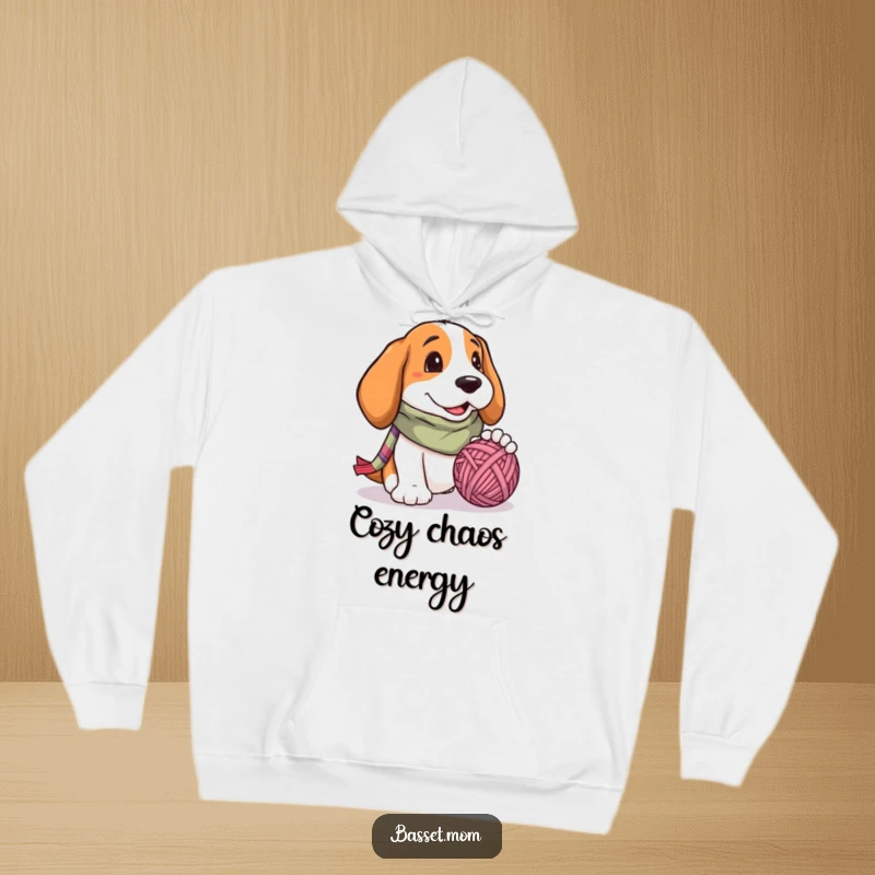 Funny Basset Hound hoodie, a cozy dog in a colorful scarf, happily playing with a giant ball of yarn, radiating cheerfulness.