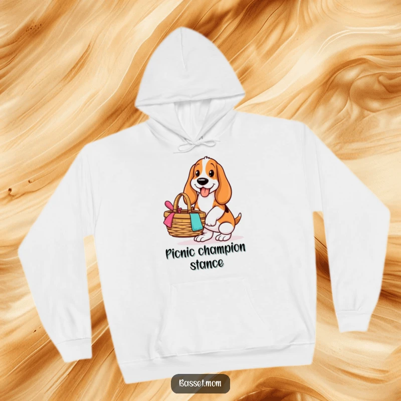 Funny Basset Hound hoodie, showing a dog with a big smile balancing a picnic basket, ready for al fresco dining.