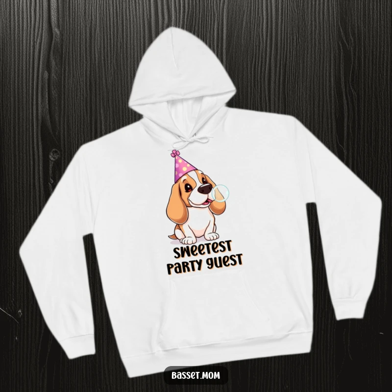 Funny Basset Hound hoodie of a dog in a party hat blowing a lollipop bubble, perfect for cozy celebrations and cheerful vibes.