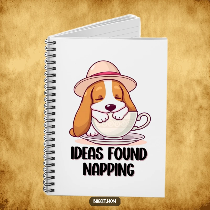 Funny Basset Hound notebook with a hound wearing a hat, napping by a teacup, ideal for jotting down notes with a humorous flair.