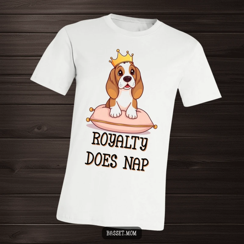 Funny Basset Hound t-shirt, a dog with a tiny crown sits on a cushion, looking regal and in charge.