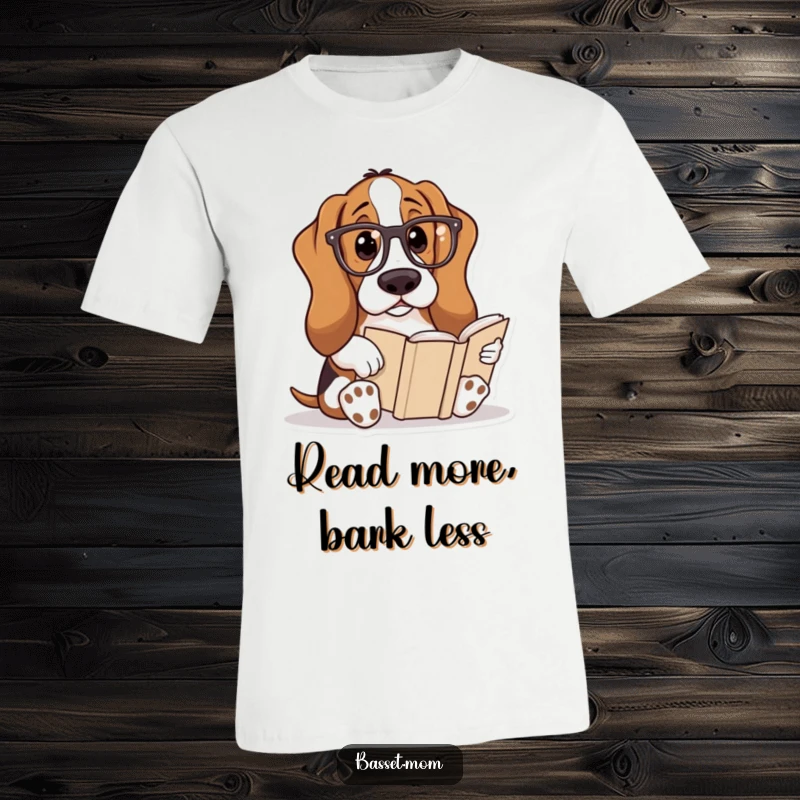 Funny Basset Hound t-shirt showing a dog wearing reading glasses, deeply absorbed in reading a book, celebrating intellect and humor.