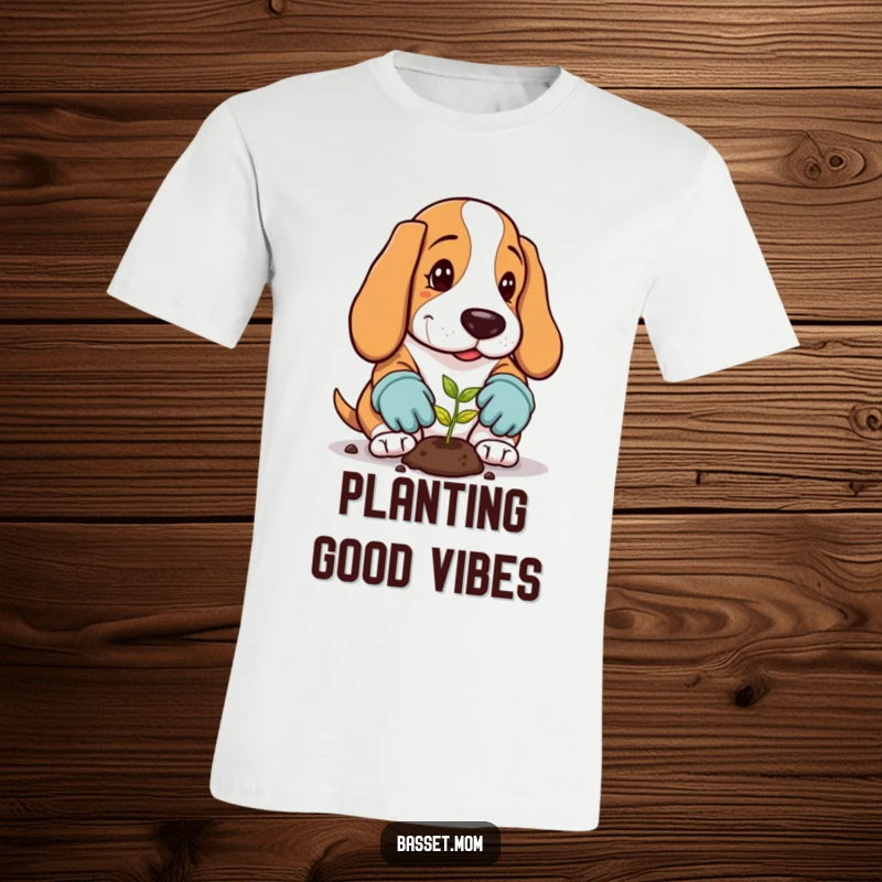 Funny Basset Hound T-Shirt: A dog in gardening gloves plants a tiny seed, celebrating nature.