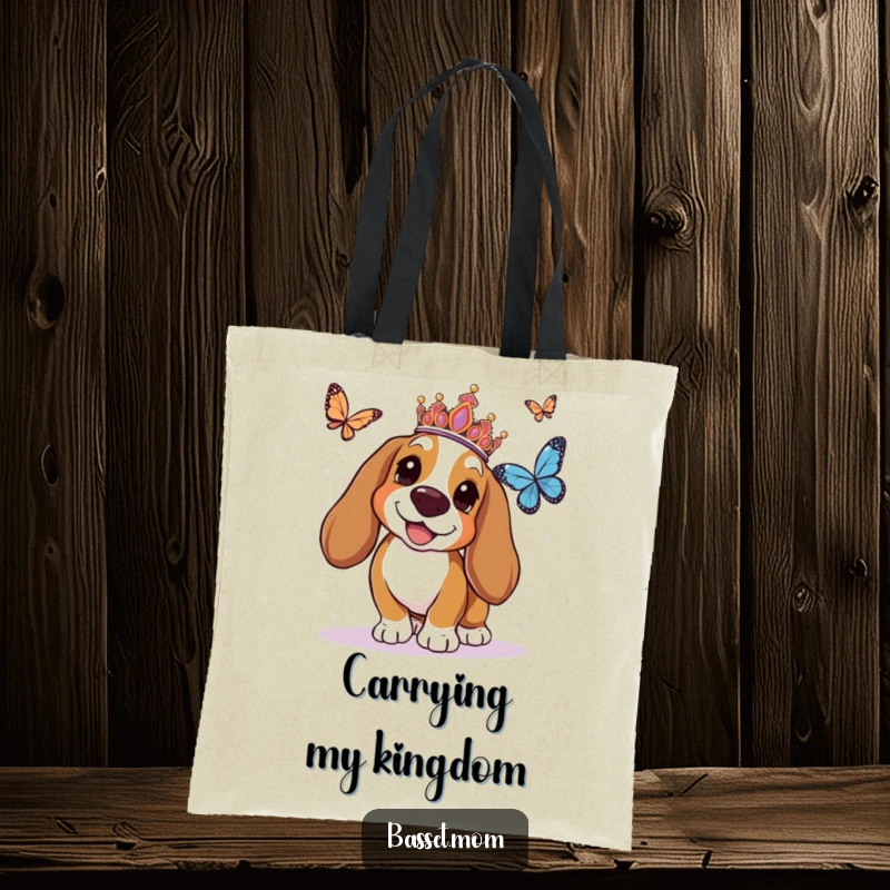 Funny Basset Hound tote bag displaying a tiara-adorned dog joyfully chasing a butterfly, perfect for stylishly carrying items.