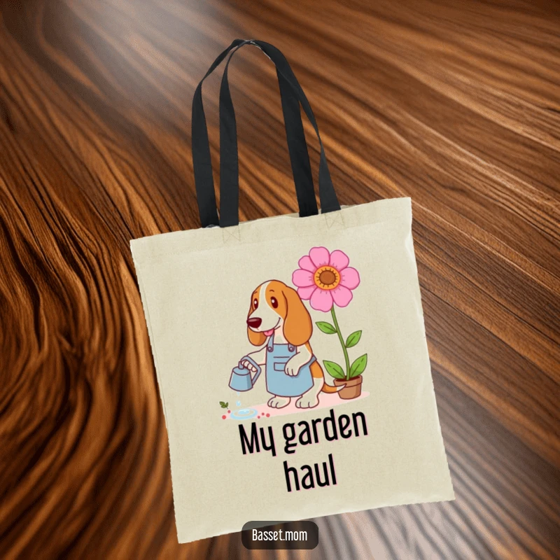 Funny Basset Hound tote bag with a dog in a gardening apron watering a giant flower, perfect for carrying garden essentials with humor.